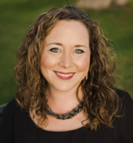 Woman with long curly brown hair smiling